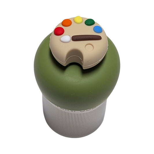 Rainbow paint pallet tea infuser  for loose leaf tea with a fine mesh stainless steel tea strainer that reads FLOAT2INFUSE on a green base with a white background