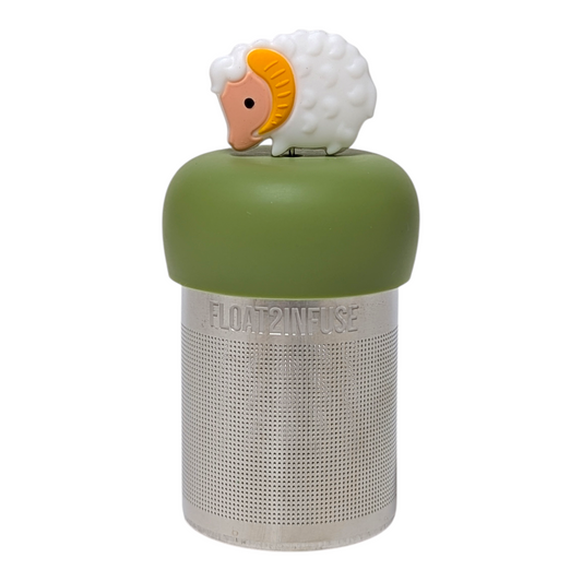 White baby bighorn sheep tea infuser  for loose leaf tea with a fine mesh stainless steel tea strainer that reads FLOAT2INFUSE on a green base with a white background