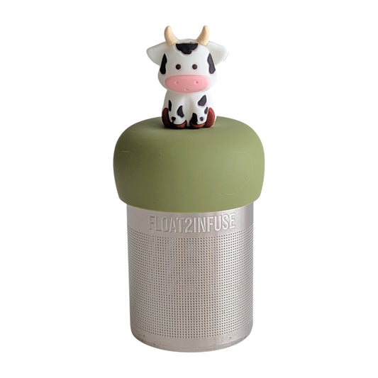 White with black spots baby cow infuser for loose leaf tea with a fine mesh stainless steel tea strainer 
that reads FLOAT2INFUSE on a green base with a white background
