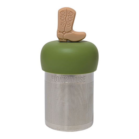 Beige cowboy boot tea infuser  for loose leaf tea with a fine mesh stainless steel tea strainer that reads FLOAT2INFUSE on a green base with a white background