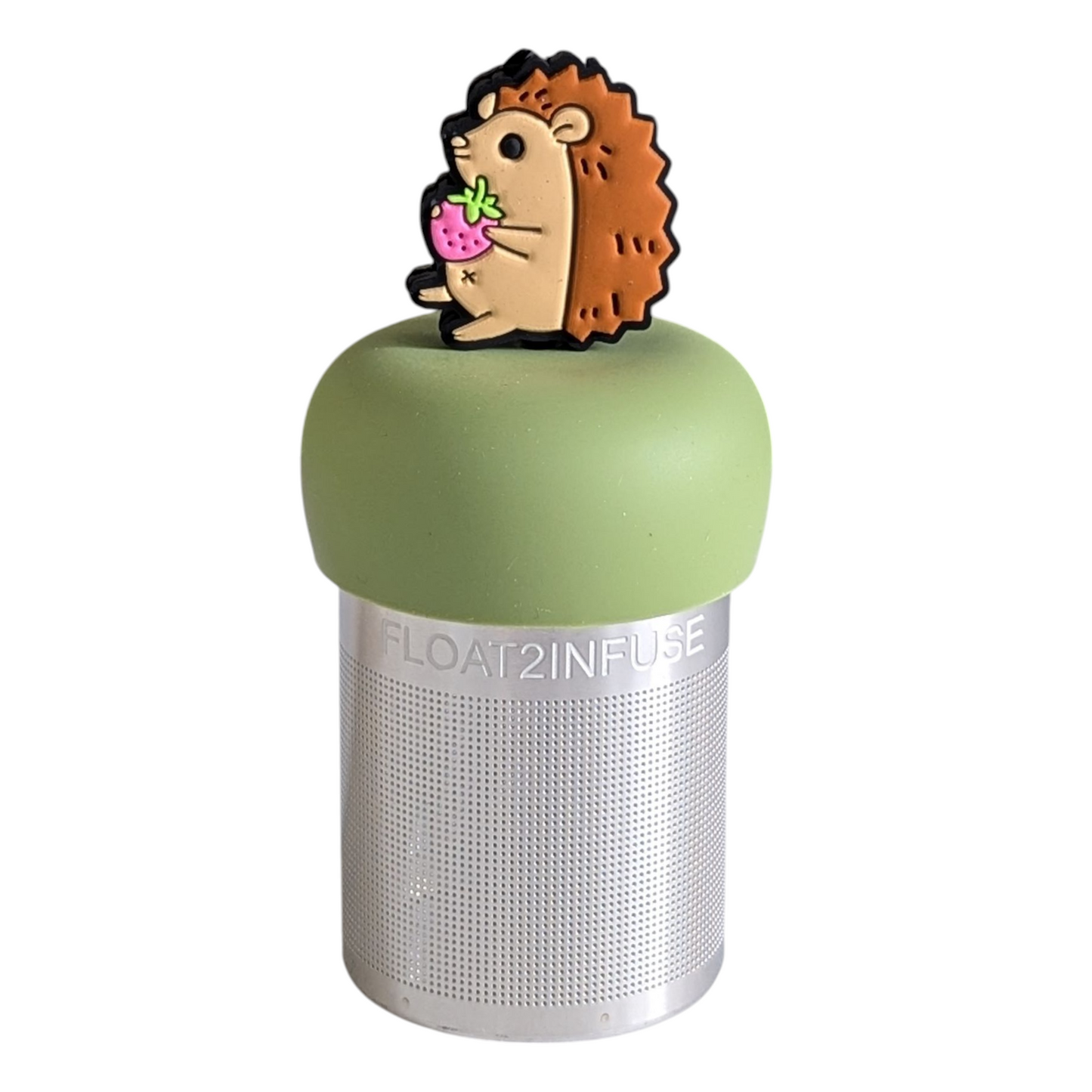 hedgehog animal holding strawberry tea infuser for loose leaf tea with a fine mesh stainless steel tea strainer that reads FLOAT2INFUSE on a green base with a white background