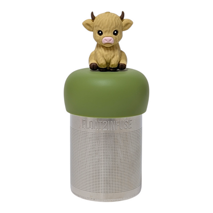 Blonde baby cow tea infuser with a green base for loose leaf tea with a fine mesh stainless steel tea strainer that reads FLOAT2INFUSE with a white background