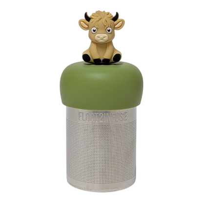 Blonde baby highland cow with black horns and hooves tea infuser for loose leaf tea with a fine mesh stainless steel tea strainer that reads FLOAT2INFUSE on a green base with a white background