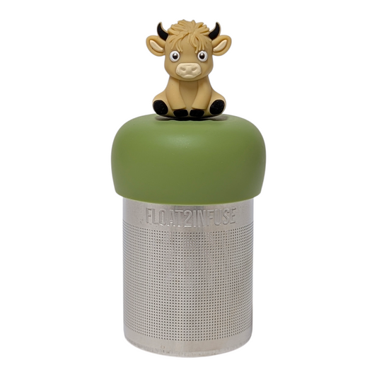 Blonde baby highland cow with black horns and hooves tea infuser for loose leaf tea with a fine mesh stainless steel tea strainer that reads FLOAT2INFUSE on a green base with a white background
