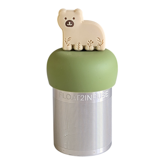 beige bear animal with leaf patterns tea infuser for loose leaf tea with a fine mesh stainless steel tea strainer that reads FLOAT2INFUSE on a green base with a white background