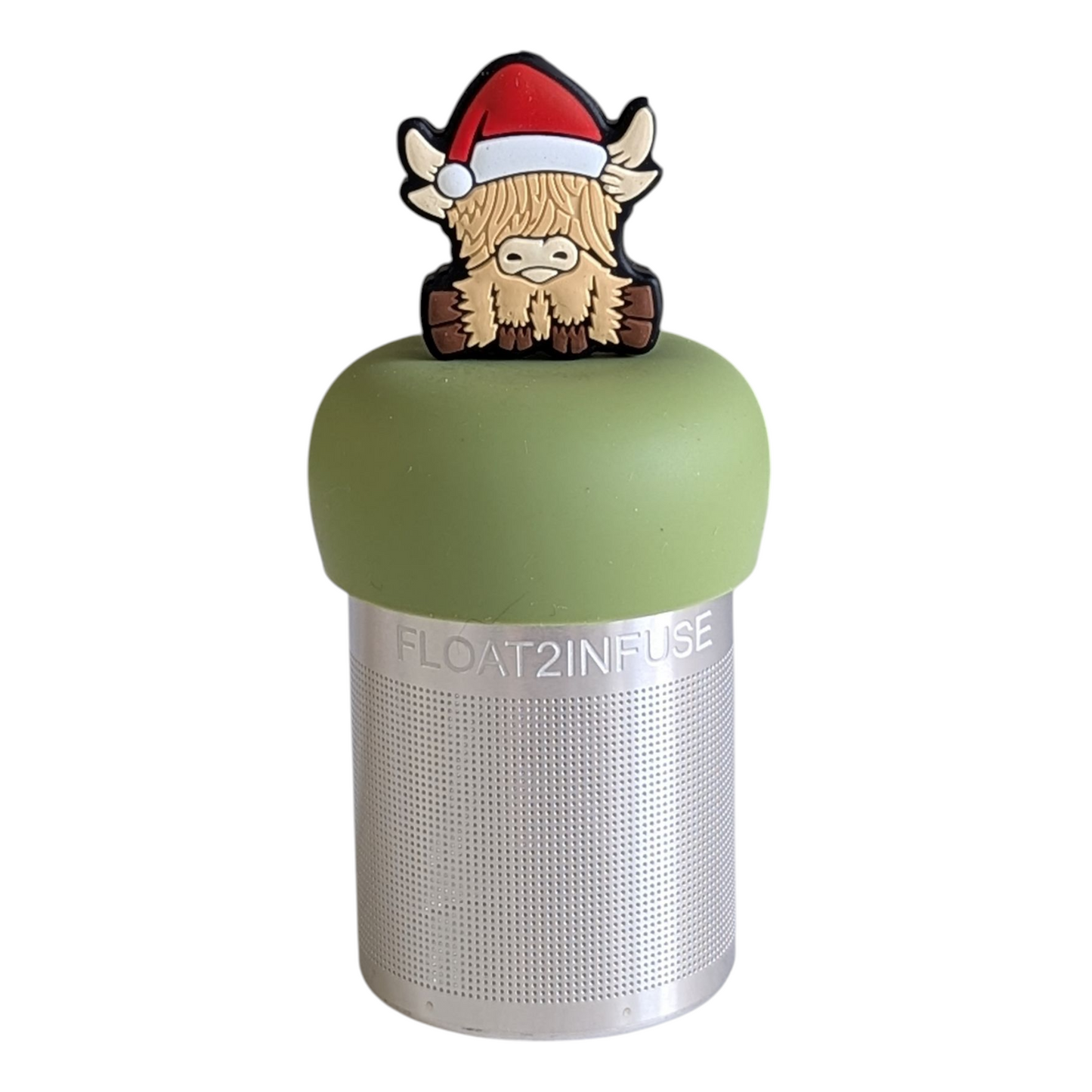 blonde highland cow animal wearing a santa hat tea infuser for loose leaf tea with a fine mesh stainless steel tea strainer that reads FLOAT2INFUSE on a green base with a white background