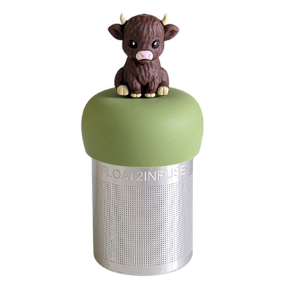 dark brown baby cow animal tea infuser for loose leaf tea with a fine mesh stainless steel tea strainer that reads FLOAT2INFUSE on a green base with a white background