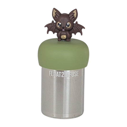 Brown bat tea infuser  for loose leaf tea with a fine mesh stainless steel tea strainer that reads FLOAT2INFUSE on a green base with a white background