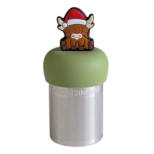 brown highland cow animal wearing a red santa hat tea infuser for loose leaf tea on a green base with a fine mesh stainless steel strainer that reads FLOAT2INFUSE with a white background