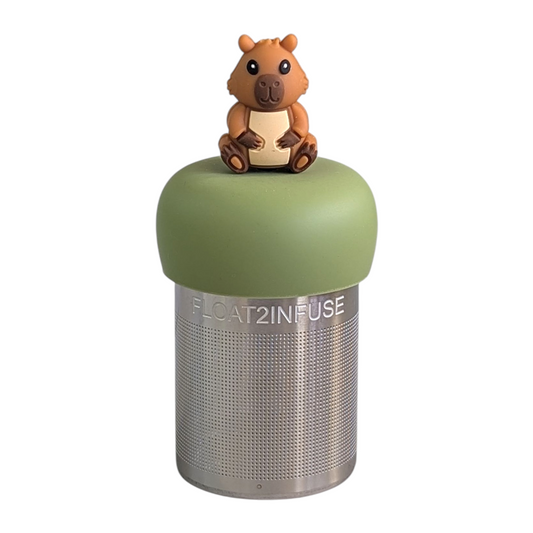 happy brown capybara tea infuser  for loose leaf tea with fine mesh stainless steel tea strainer that reads FLOAT2INFUSE on a green base with white background