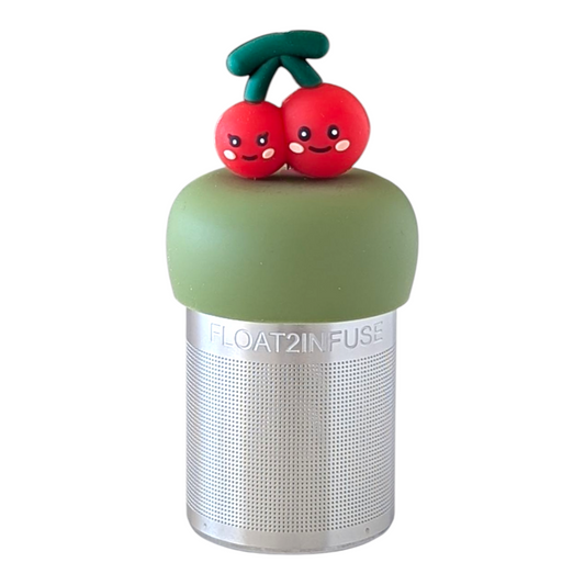 two smiling red cherries connected by a green stem tea infuser for loose leaf tea with a fine mesh stainless steel tea strainer  that reads FLOAT2INFUSE on a green base with a white background