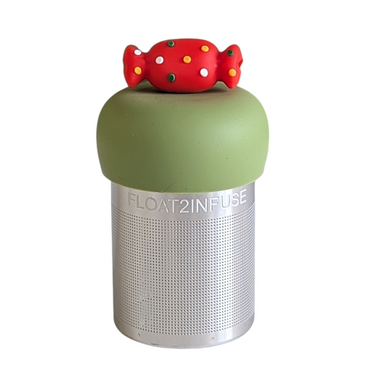 red holiday candy with green, yellow, and white polka dots tea infuser for loose leaf tea with a fine mesh stainless steel tea strainer that reads FLOAT2INFUSE on a green base with a white background