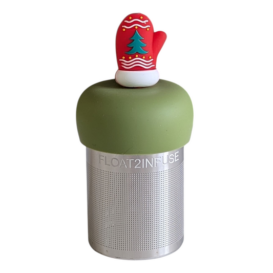 red mitten with green christmas tree and white accents tea infuser for loose leaf tea with a fine mesh stainless steel tea strainer that reads FLOAT2INFUSE on a green base with a white background