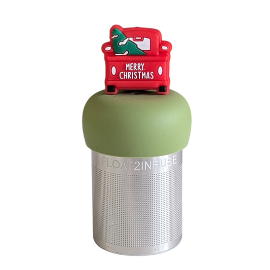 red pickup truck with christmas tree in the back and text "merry christmas" on the back tea infuser for loose leaf tea with a fine mesh stainless steel tea strainer that reads FLOAT2INFUSE on a green base with a white background