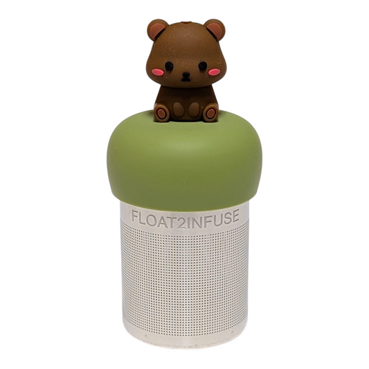 cute brown bear with pink cheeks tea infuser for loose leaf tea with a fine mesh stainless steel tea strainer  that reads FLOAT2INFUSE on a green base with a white background