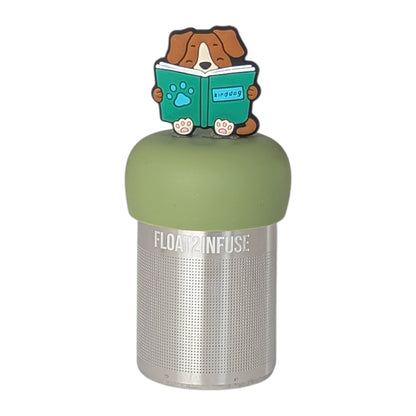 Brown dog sitting holding green book tea infuser  for loose leaf tea with a fine mesh stainless steel tea strainer that reads FLOAT2INFUSE on a green base with a white background