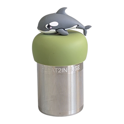 grey and white dolphin tea infuser  for loose leaf tea with fine mesh stainless steel tea strainer that reads FLOAT2INFUSE on a green base with white background