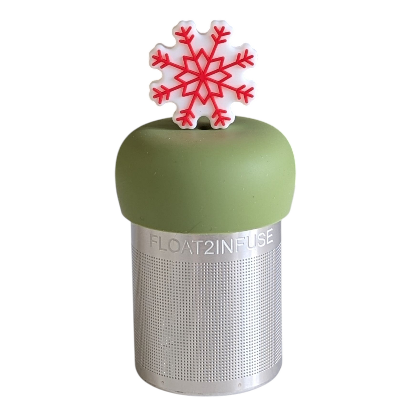 red and white holiday snowflake tea infuser for loose leaf tea with a fine mesh stainless steel tea strainer that reads FLOAT2INFUSE on a green base with a white background