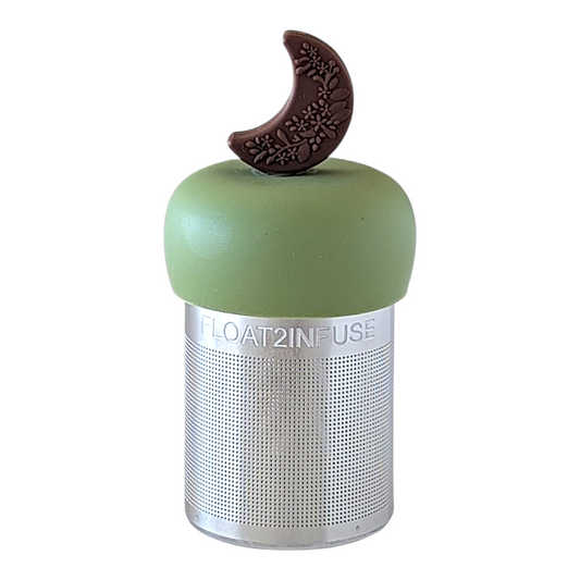 Brown crescent moon with floral pattern tea infuser for loose leaf tea with a fine mesh stainless steel tea strainer  that reads FLOAT2INFUSE on a green base with a white background