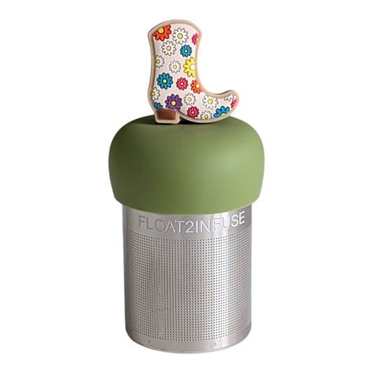 white cowboy boot with multicolored floral pattern tea infuser for loose leaf tea with a fine mesh stainless steel tea strainer that reads FLOAT2INFUSE on a green base with a white background