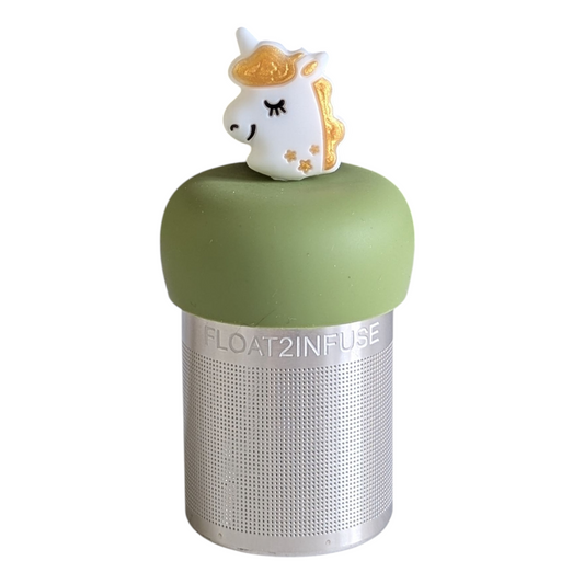 smiling white unicorn with gold mane tea infuser for loose leaf tea with a fine mesh stainless steel tea strainer 
that reads FLOAT2INFUSE on a green base with a white background