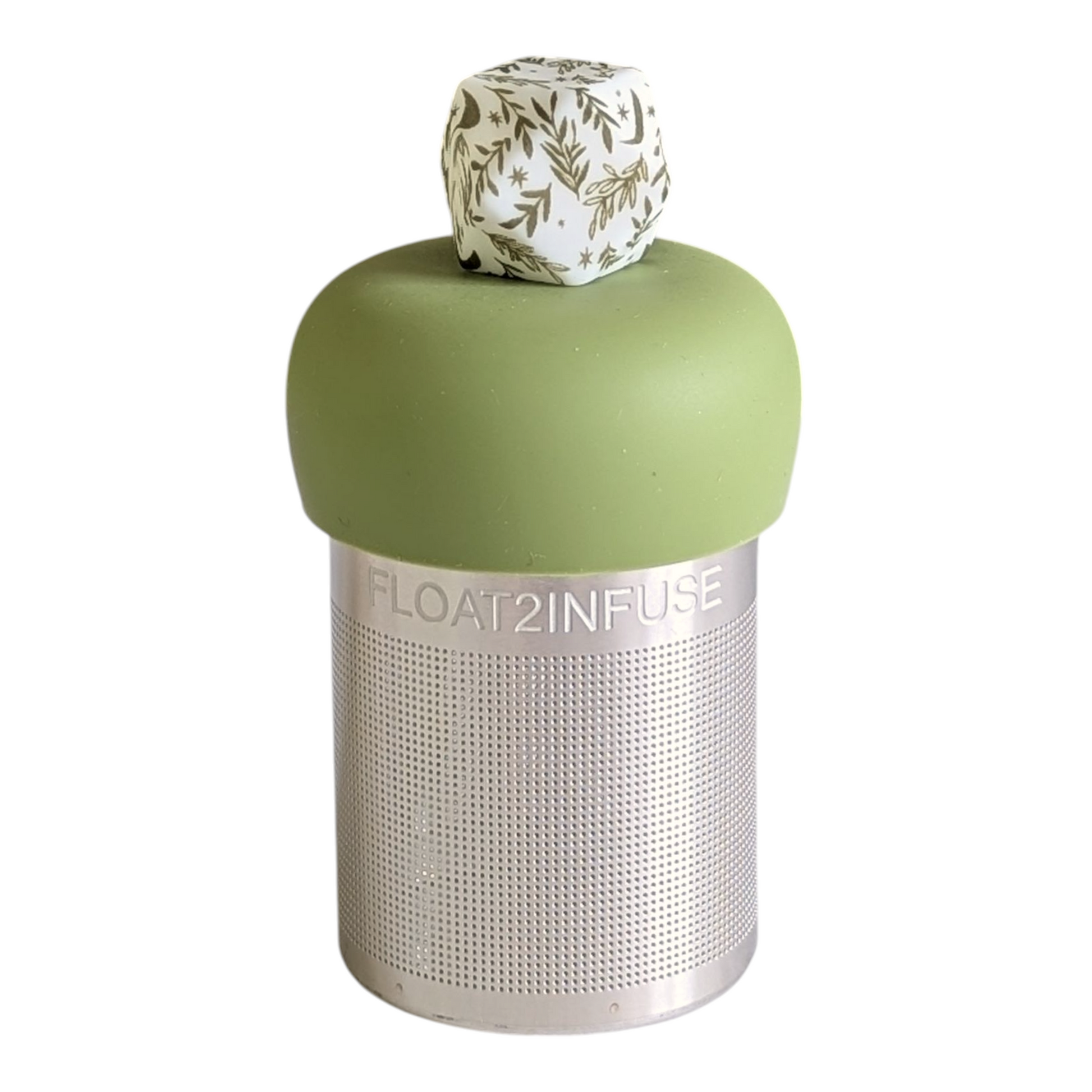 white hexagon with green leaf pattern tea infuser for loose leaf tea with a fine mesh stainless steel tea strainer that reads FLOAT2INFUSE on a green base with a white background
