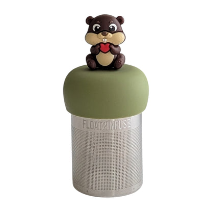 beaver animal holding a red heart tea infuser for loose leaf tea on a green base with a fine mesh stainless steel tea strainer that reads FLOAT2INFUSE with a white background