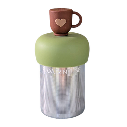 Brown tea mug with a beige heart tea infuser for loose leaf tea with a fine mesh stainless steel tea strainer that reads FLOAT2INFUSE on a green base  with a white background