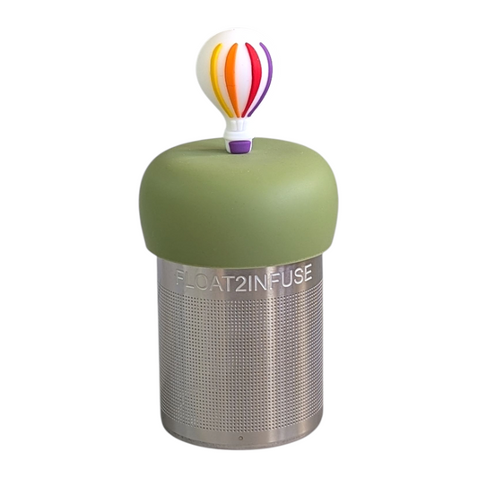 hot air ballon with rainbow stripes and purple basket tea infuser for loose leaf tea with a fine mesh stainless steel tea strainer that reads FLOAT2INFUSE on a green base 
with a background