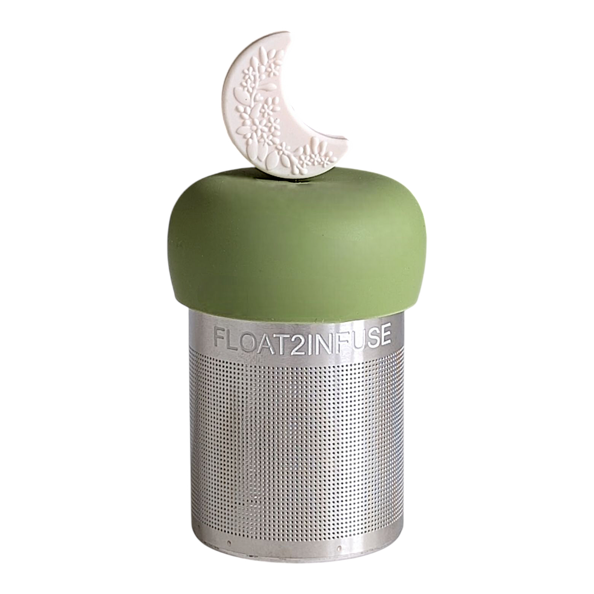 ivory crescent moon with raised floral pattern tea infuser  for loose leaf tea with fine mesh stainless steel tea strainer that reads FLOAT2INFUSE on a green base with white background