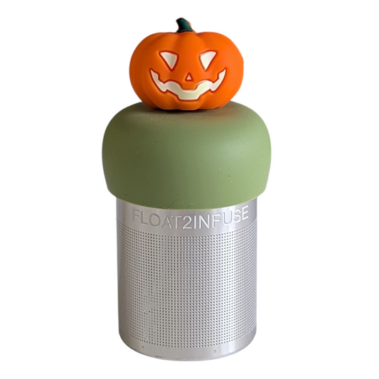 Jack-o-lantern pumpkin tea infuser for loose leaf tea with a fine mesh stainless steel tea strainer that reads FLOAT2INFUSE on a green base with a white background