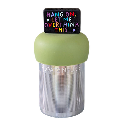 black rectangle with text that reads "hang on, let me overthink this" in rainbow letters tea infuser  for loose leaf tea with fine mesh stainless steel tea strainer that reads FLOAT2INFUSE on a green base with a white background