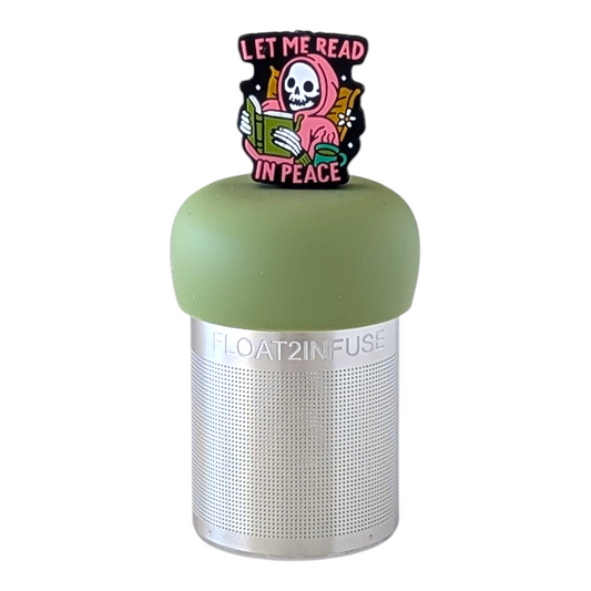 Smiling grim reaper in a pink robe holding a book with the text "let me read in peace" tea infuser for loose leaf tea with a fine mesh stainless steel tea strainer  that reads FLOAT2INFUSE on a green base with a white background