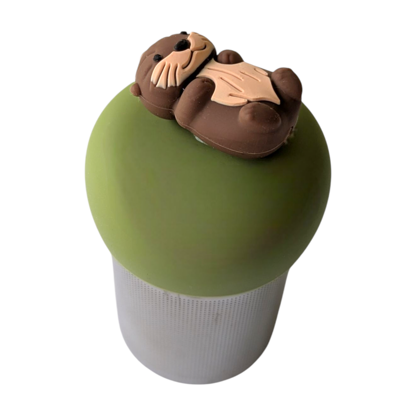 brown otter floating on its back tea infuser for loose leaf tea with a fine mesh stainless steel tea strainer that reads FLOAT2INFUSE on a green base with a white background
