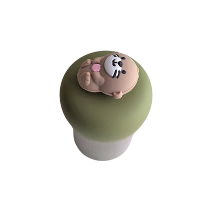 cute little otter floating on it's back holding a pink seashell tea infuser for loose leaf tea with a fine mesh stainless steel tea strainer 
that reads FLOAT2INFUSE on a green base with a white background