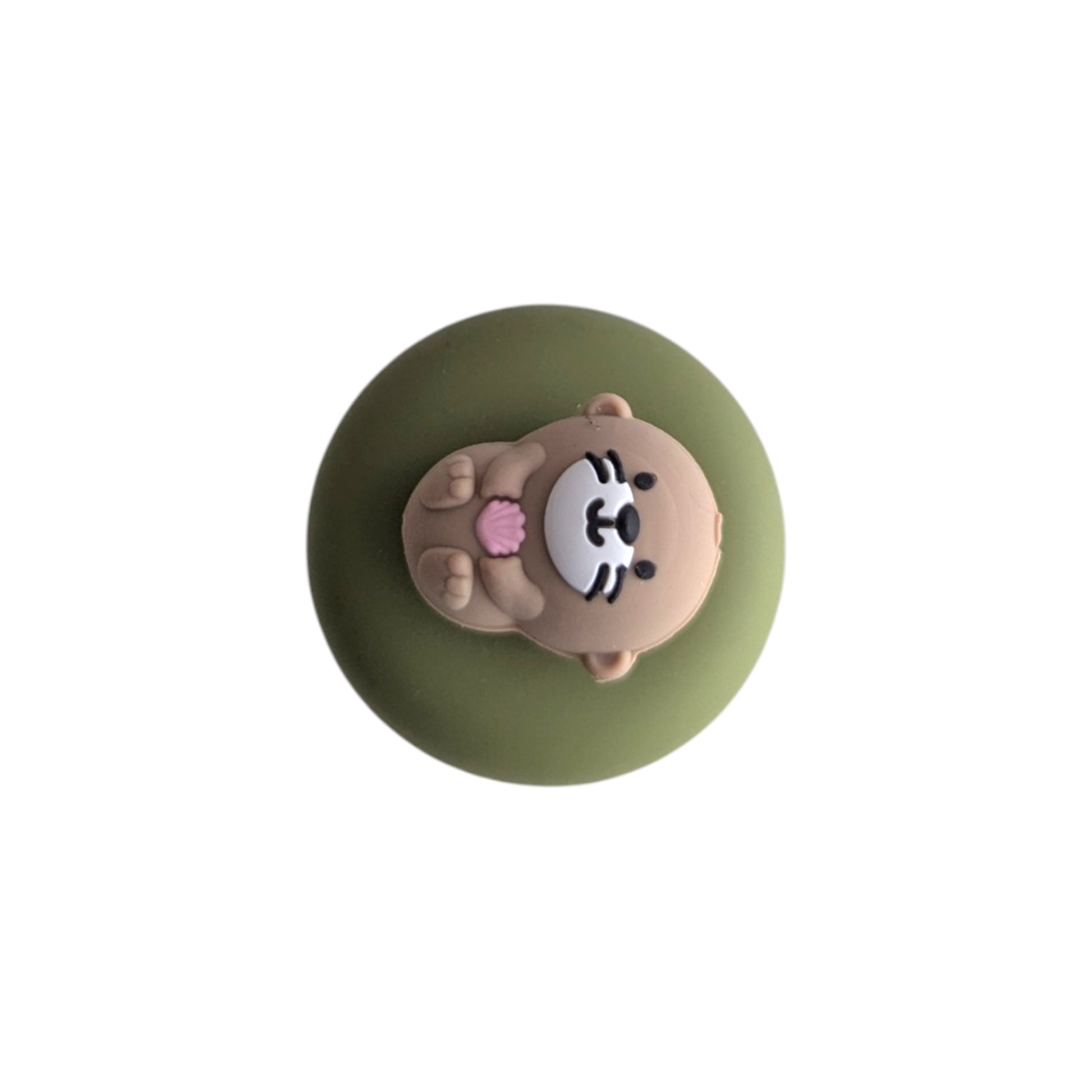 cute little otter floating on it's back holding a pink seashell tea infuser for loose leaf tea with a fine mesh stainless steel tea strainer 
that reads FLOAT2INFUSE on a green base with a white background