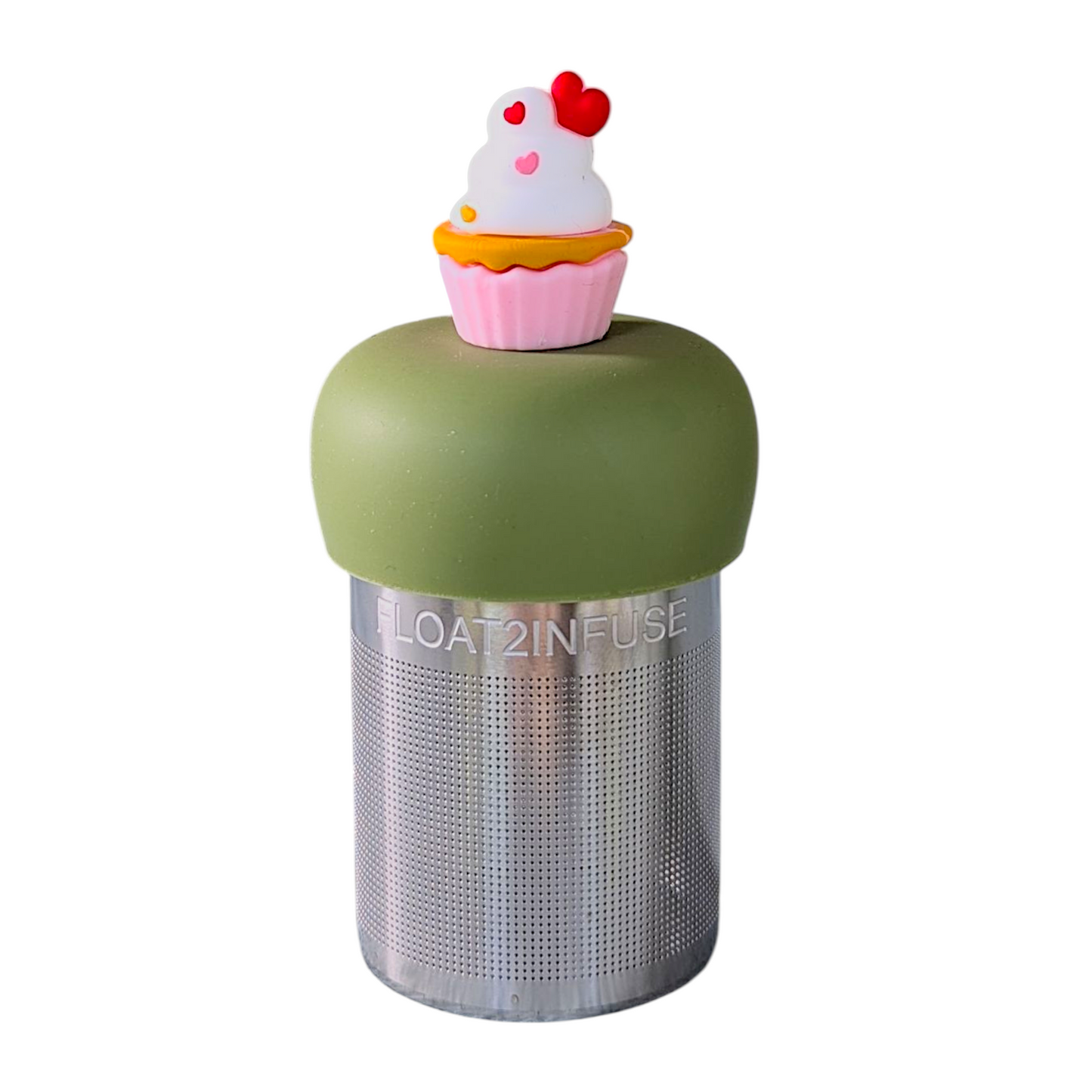 vanilla cupcake in a pink wrapper with white icing and heart shaped sprinkles tea infuser for loose leaf tea with a fine mesh stainless steel tea strainer that reads FLOAT2INFUSE on a green base  with a white background