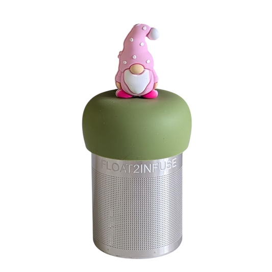 gnome with a long white beard and wearing light light pink clothing with white polka dots on the hat tea infuser for loose leaf tea with a fine mesh stainless steel strainer that reads FLOAT2INFUSE on a green base with a white background