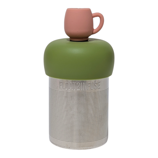 Pink mug tea infuser  for loose leaf tea with a fine mesh stainless steel tea strainer that reads FLOAT2INFUSE on a green base with a white background