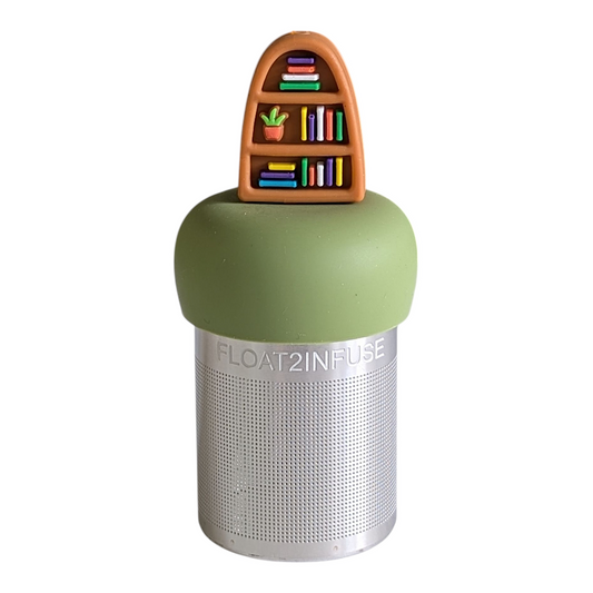brown bookshelf with books and plants tea infuser for loose leaf tea with a fine mesh stainless steel tea strainer that reads FLOAT2INFUSE on a green base with a white background