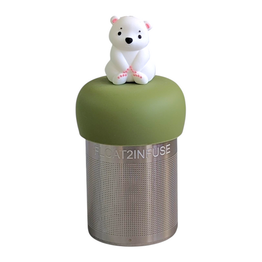 cute white polar bear tea infuser  for loose leaf tea with fine mesh stainless steel tea strainer that reads FLOAT2INFUSE on a green base with a white background