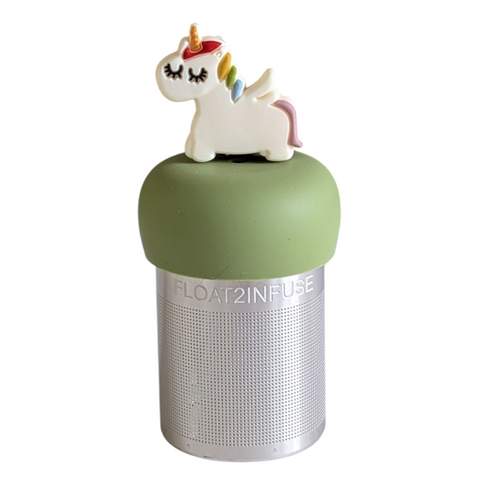 white unicorn with a rainbow mane and gold horn tea infuser for loose leaf tea  with a fine mesh stainless steel strainer that reads FLOAT2INFUSE on a green base with a white background