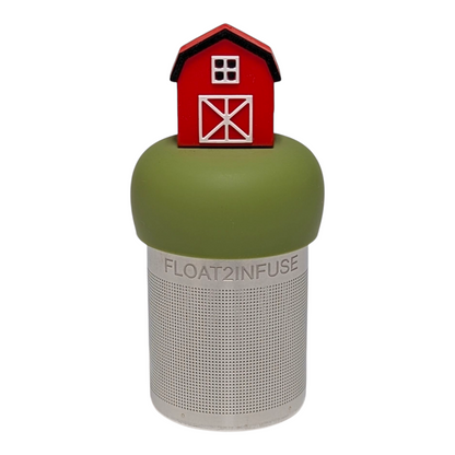 Red barn tea infuser for loose leaf tea with a fine mesh stainless steel tea strainer  that reads FLOAT2INFUSE on a green base with a white background