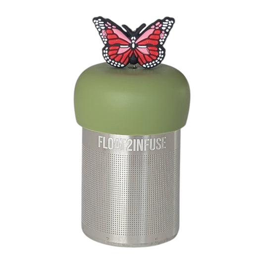 Red and pink butterfly tea infuser  for loose leaf tea with a fine mesh stainless steel tea strainer that reads FLOAT2INFUSE on a green base with a white background