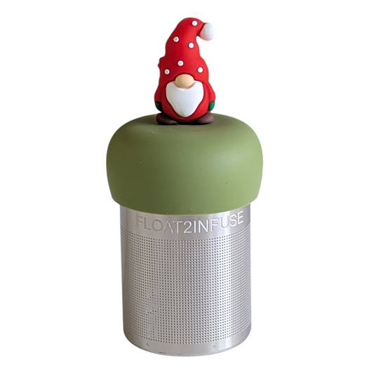 gnome with a long white beard wearing red with white polka dots on the hat and green mittens tea infuser for loose leaf tea with a fine mesh stainless steel tea strainer 
that reads FLOAT2INFUSE on a green base with a white background