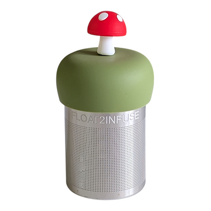 red mushroom tea infuser for loose leaf tea with a fine mesh stainless steel tea strainer that reads FLOAT2INFUSE on a green base with a white background