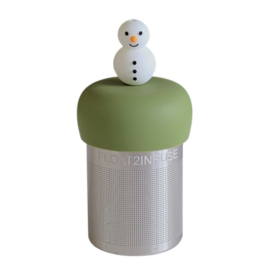 smiling white snowman with orange carrot nose and black buttons tea infuser for loose leaf tea with a fine mesh stainless steel tea strainer that reads FLOAT2INFUSE on a green base with a white background