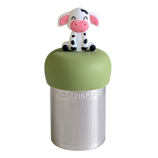 happy black and white spotted cow  tea infuser for loose leaf tea with a fine mesh stainless steel tea strainer that reads FLOAT2INFUSE on a green base with a white background