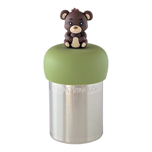brown teddy bear with tongue sticking out for loose leaf tea with fine mesh stainless steel tea strainer that reads FLOAT2INFUSE on a green base with a white background