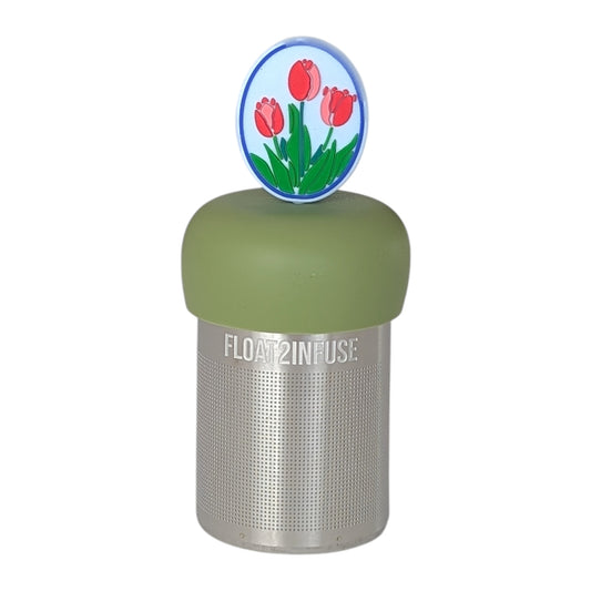 Oval framed pink and red tulips tea infuser  for loose leaf tea with a fine mesh stainless steel tea strainer that reads FLOAT2INFUSE on a green base with a white background